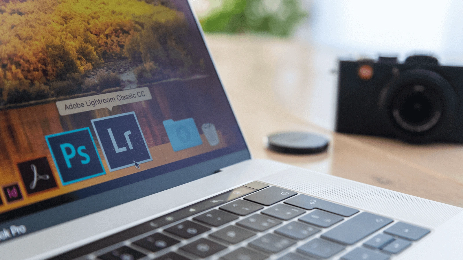 Alt: Laptop displaying Adobe software highlighting reasons to outsource video editing to save on tools.