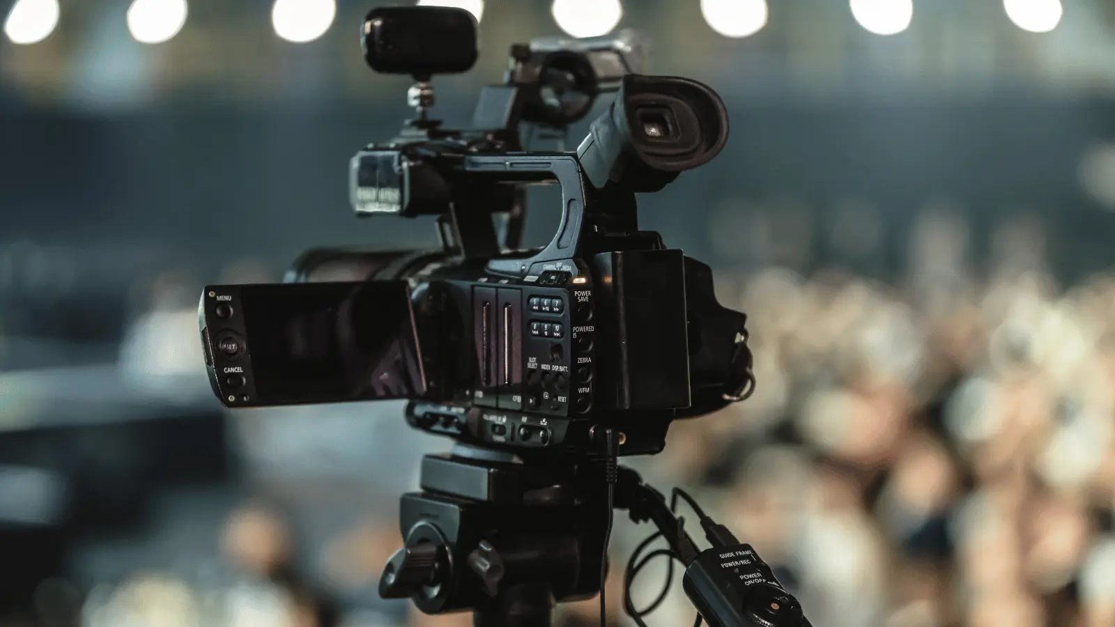 Professional camera setup for corporate video production capturing a live event with an audience.