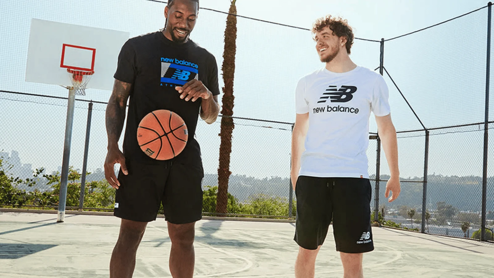 Two basketball players in New Balance gear on a court demonstrating sports marketing examples through branded apparel.